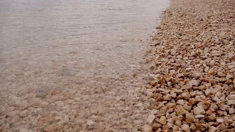 Small sea waves hittig pebble shore Stock Footage 77496874