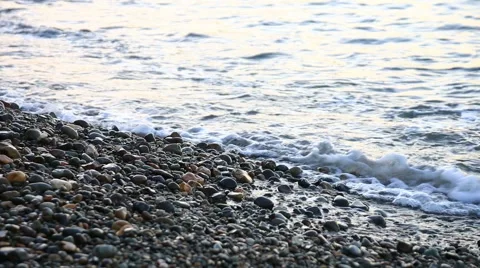 Small sea waves run on the stony seashore Stock Footage 45942738