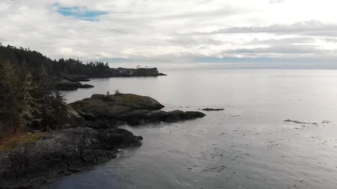 A small seaside condo development situated on the edge of a cliff overlooking Stock Footage 118621792