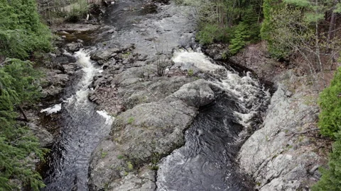 Small section of rapids with a big rock, 4k, slow-mo drone shot Stock Footage 243539082