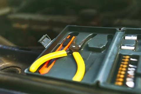A small set of tools, open It stands on the hood of the car. preparing for a  Stock Photos