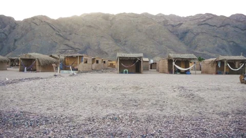 A Small Settlement In A Desert Mountain Area With Reed Huts Stock Footage 226962542