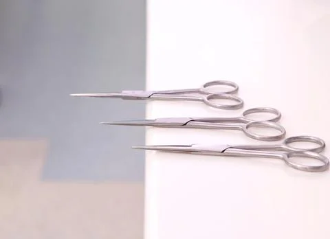Small sharp surgical scissors placed on table unattended. Stock Photos