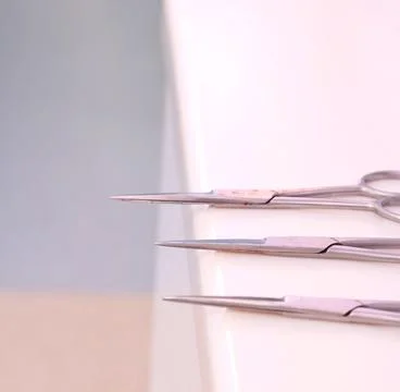 Small sharp surgical scissors placed on table unattended. Stock Photos