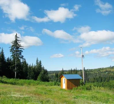 Small shed with clouds Stock Photos