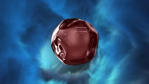 A small, shiny, metallic object is floating in the air Video stock 271065603