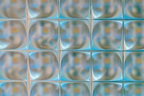 Small shiny square tiles, close-up. Unusual backgrounds and textures. Stock Photos
