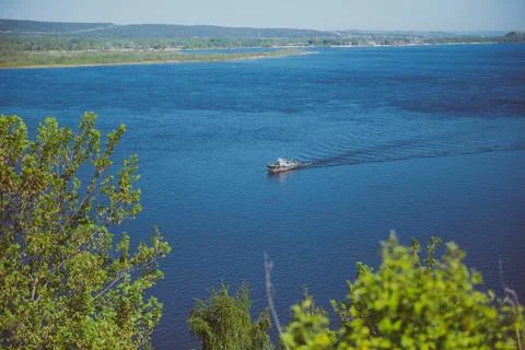 Small ship in the center of the river Stock Photos