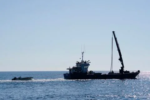 Small ship with a crane Stock Photos