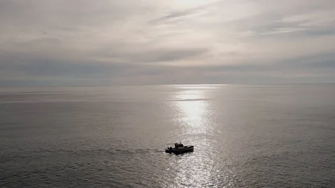 Small ship crossing on sea sunset slow motion Stock Footage 106628714