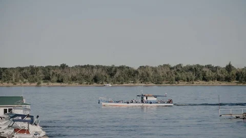A small ship floating on the river Stock Footage 105840491