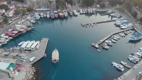 A small ship or boat sails into the bay at dawn. Stock Footage 221021894
