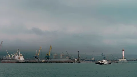 A Small Ship Sails the Harbor of the Industrial Zone of the Port City Stock Footage 88837494