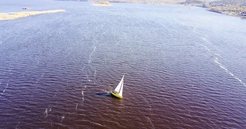 Small ship sails. Sunny landscape of the river in windy weather. Stock Footage 74509636