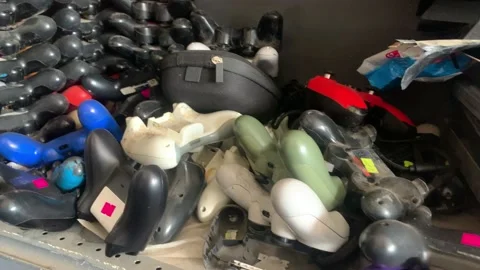 In small shop full of stacked Ps4 and xbox controller for maintenance and Stock Footage 209553335