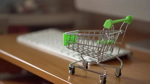 A small shopping basket stands on the computer desk Stock Footage 152513389