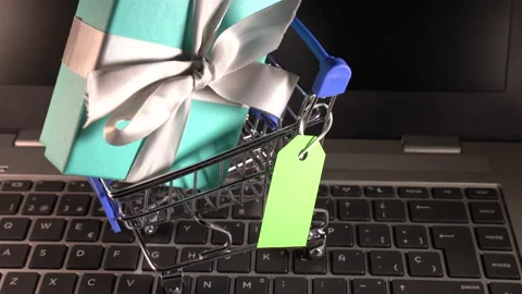 Small shopping cart with a gift inside and a green tag Stock Footage 158833944