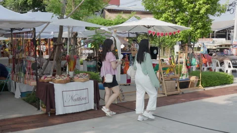 Small shops selling clothes and fashion accessories at the Greenheart market Stock Footage 243799666