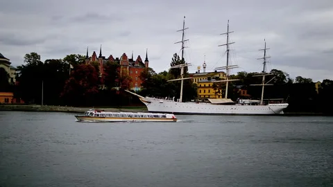 Small sightseeing boat during its cruise trip passing by big old white boat. Video stock 152582059