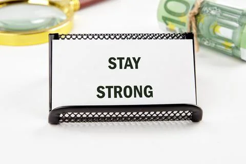 A small sign displays the uplifting message stay strong set against a backdrop Stock Photos