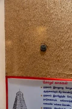 A small silver coin is on a wall. in Chennai Stock Photos