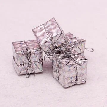 Small silver gift boxes tied with rope on white Stock Photos