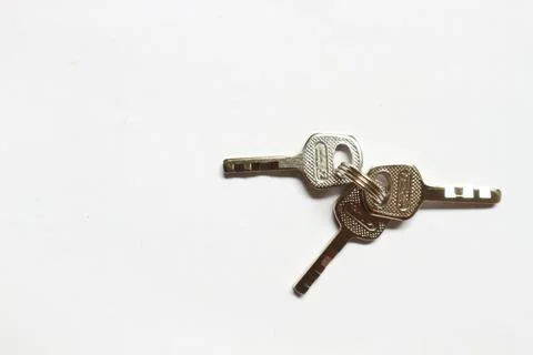 Small silver padlock key on a white background Stock Photos