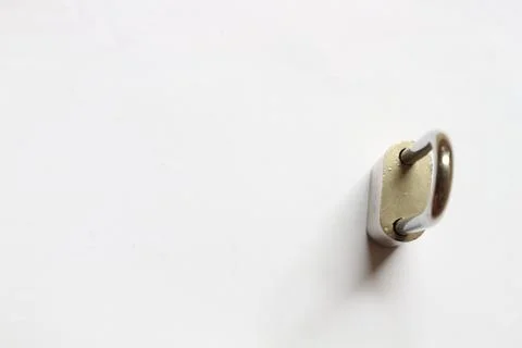 Small silver padlock key on a white background Stock Photos