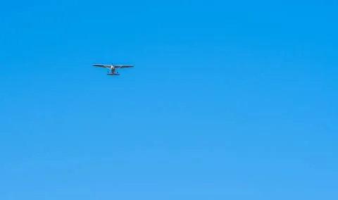Small single engine aircraft in clear blue sky Stock Photos