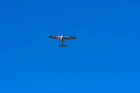 Small single engine aircraft in clear blue sky Stock Photos