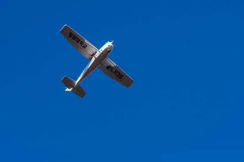 Small single engine aircraft in clear blue sky Stock Photos