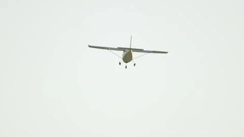 Small single engine propeller airplane landing in the sky Stock Footage 344257788