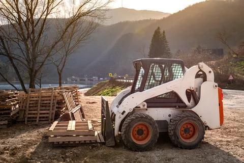 Small skid steer loader on construction site Stock Photos