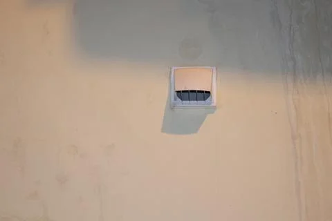 Small skylight window on a flat sandy colored roof surface with soft shadow Stock Photos