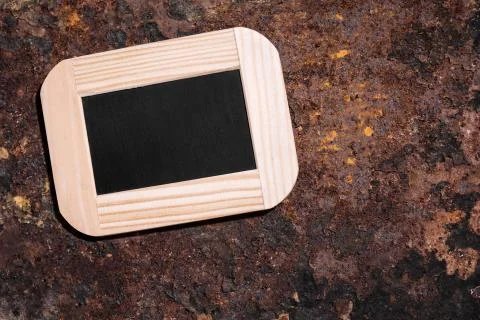 Small slate with copyspace on rusty background Stock Photos