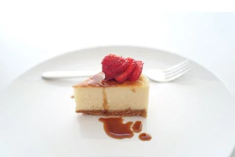 Small slice of cheesecake on a big plate Stock Photos
