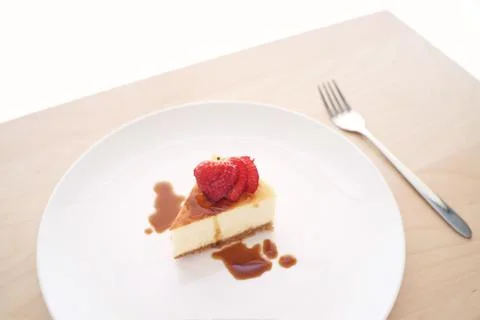 Small slice of cheesecake on a big plate Foto stock
