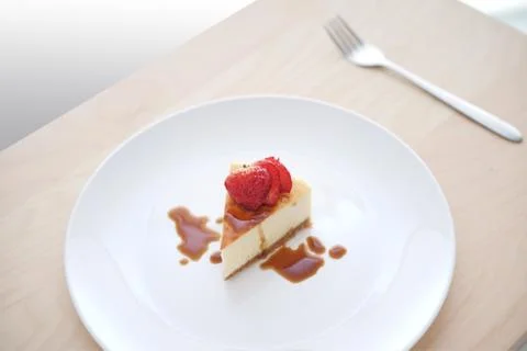 Small slice of cheesecake on a big plate Stock Photos