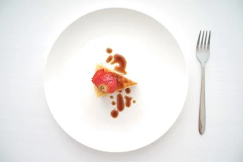 Small slice of cheesecake on a big plate Stock Photos