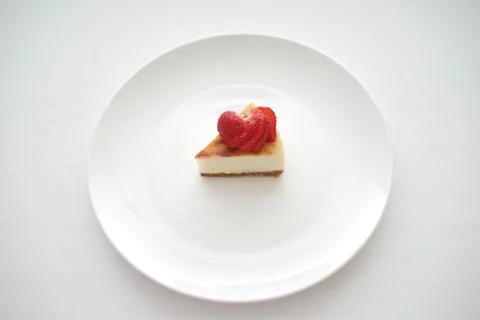 Small slice of cheesecake on a big plate Stock Photos