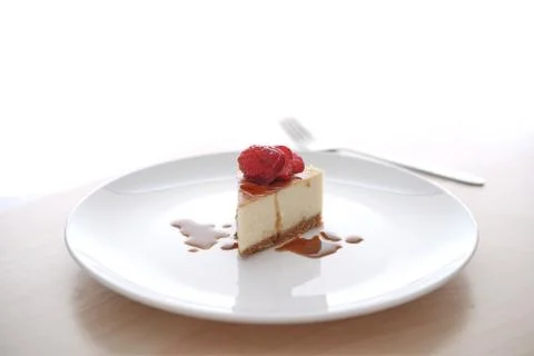 Small slice of cheesecake on a big plate Stock Photos