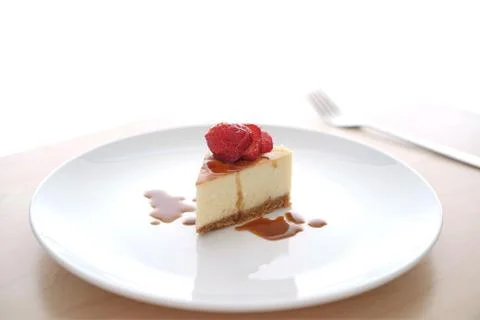 Small slice of cheesecake on a big plate Fotos Stock