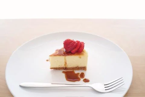 Small slice of cheesecake on a big plate Stock Photos