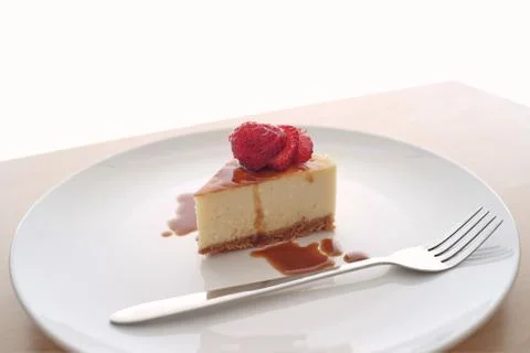 Small slice of cheesecake on a big plate Stock Photos