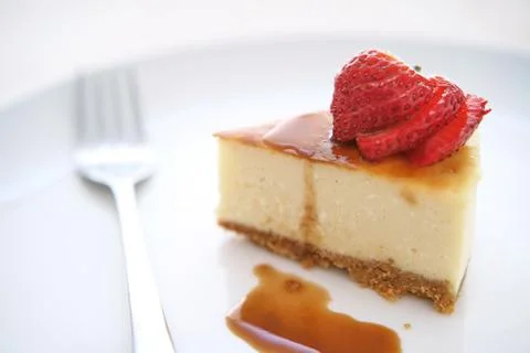 Small slice of cheesecake on a big plate Stock Photos