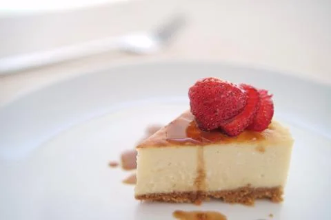 Small slice of cheesecake on a big plate Stock Photos