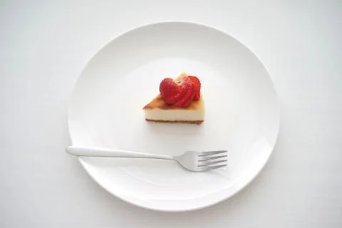 Small slice of cheesecake on a big plate Stock Photos