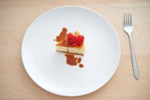Small slice of cheesecake on a big plate Stock Photos