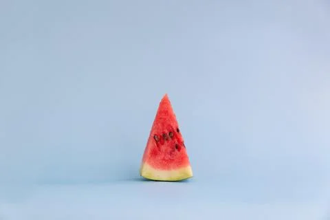 Small slice of watermelon on a blue background Stock Photos