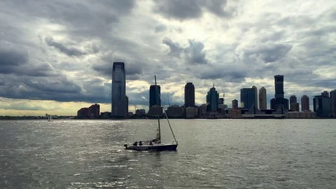 Small, Slow Sailboat and Quick Water Taxi at Sunset (Jersey City, NJ Skyline) Stock Footage 77149989